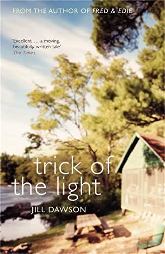 Book cover with lakeside scene, picnic table, and small green building.
