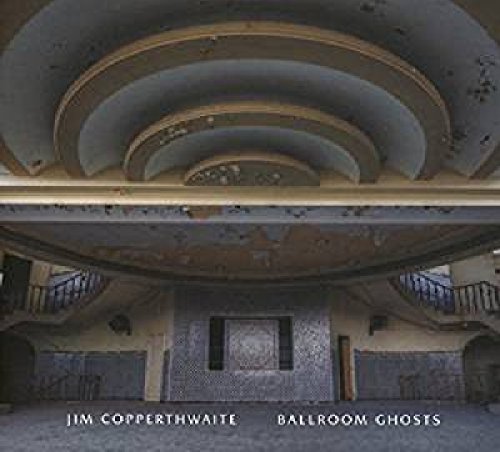 "Album cover featuring a dilapidated, circular ballroom interior with spiral staircase and faded decor."