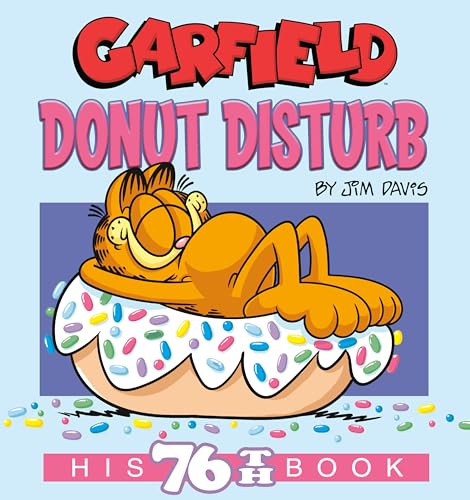 Garfield the cat sleeping on a large donut with colorful sprinkles.