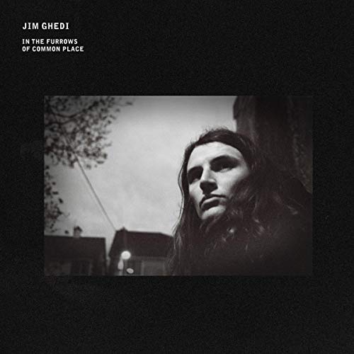 Black and white album cover featuring a portrait of a long-haired person.