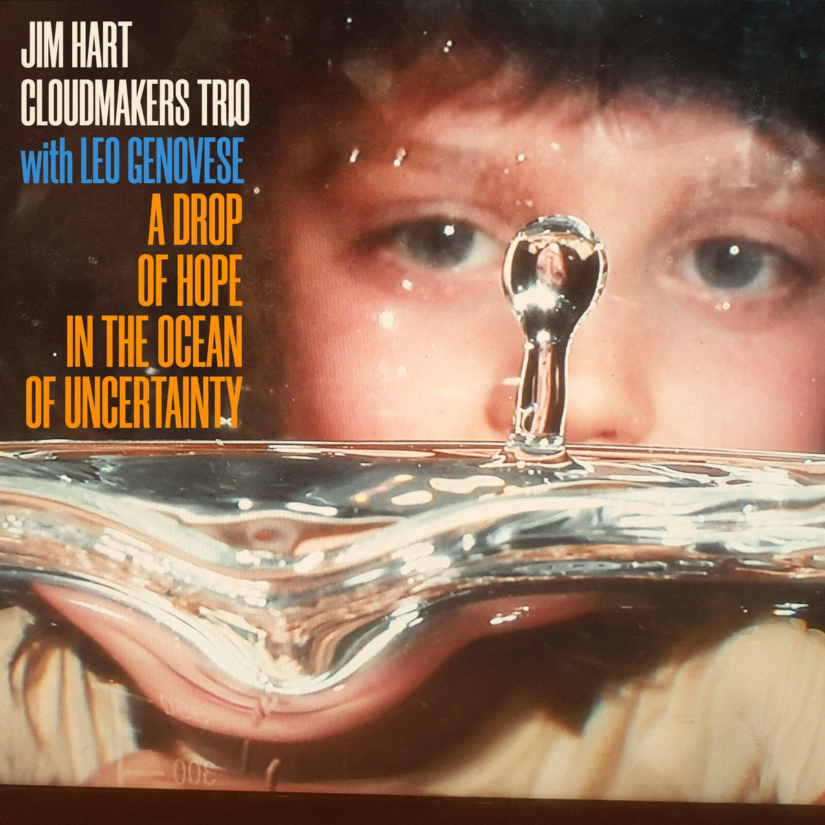 Vinyl album cover featuring a close-up of water and a golden key.