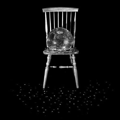 Black and white album cover featuring a chair and disco ball.