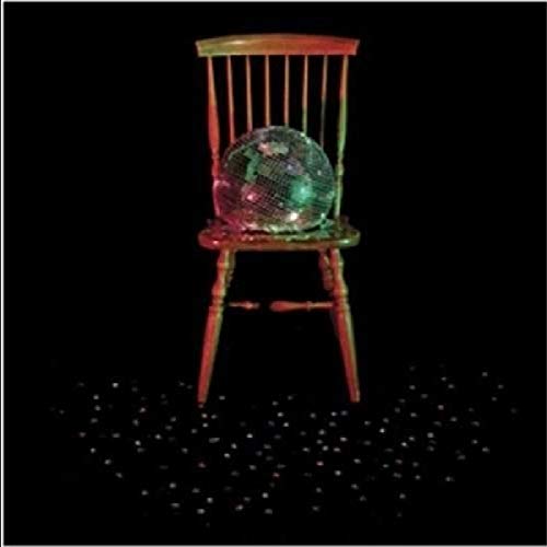Black background with a chair, disco ball, and scattered glitter.