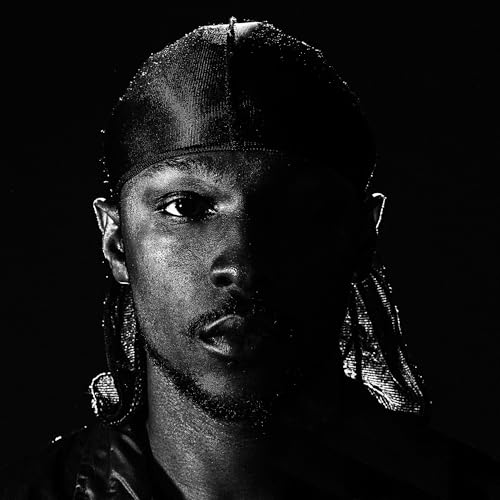 Black and white portrait of Jme with dreadlocks and a durag.
