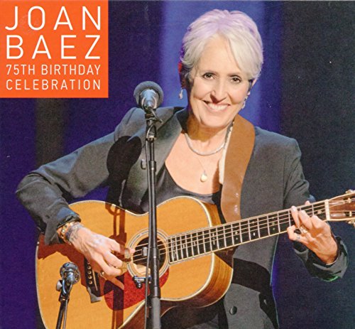 Joan Baez smiling, playing guitar on stage for her 75th birthday.