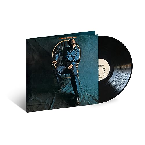 João Donato album cover and black vinyl record on white background.