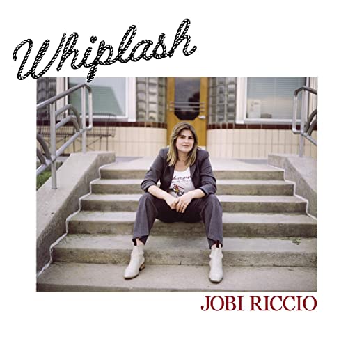 Album cover for Jobi Riccio’s “Whiplash” featuring a woman on steps.