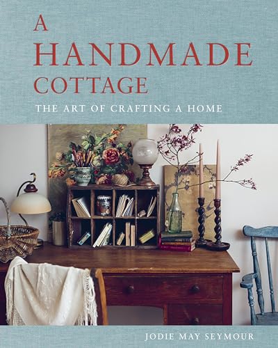 Book cover with a rustic wooden desk, flowers, and decorative objects.