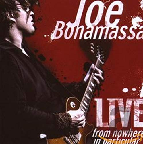 Joe Bonamassa playing an electric guitar against a dark red background with white text.