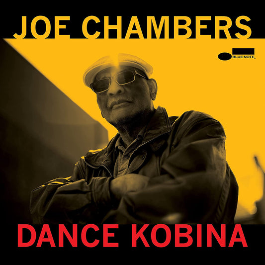"Album cover with man wearing sunglasses and hat, yellow background, black and red text."