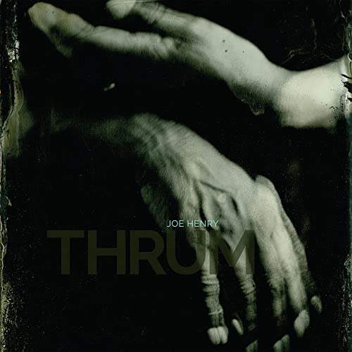 Joe Henry's "Thrum" vinyl album cover, featuring blurred hands and dark tones.