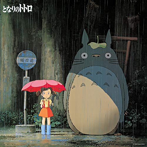 Totoro and a girl with a red umbrella wait in the rain.