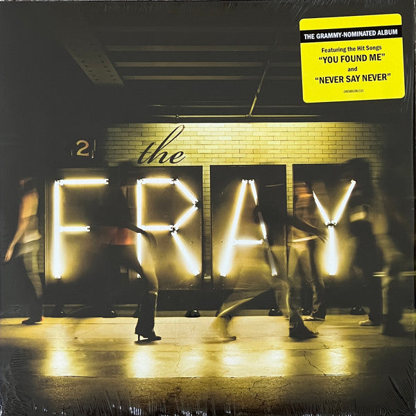 Vinyl record cover featuring blurred figures in front of illuminated lettering.