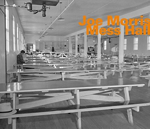"CD cover with a black-and-white cafeteria image and orange title text."
