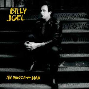 Black and white album cover featuring Billy Joel seated on stairs.