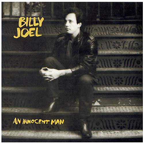 Billy Joel sitting on ornate stone steps on the album cover An Innocent Man.