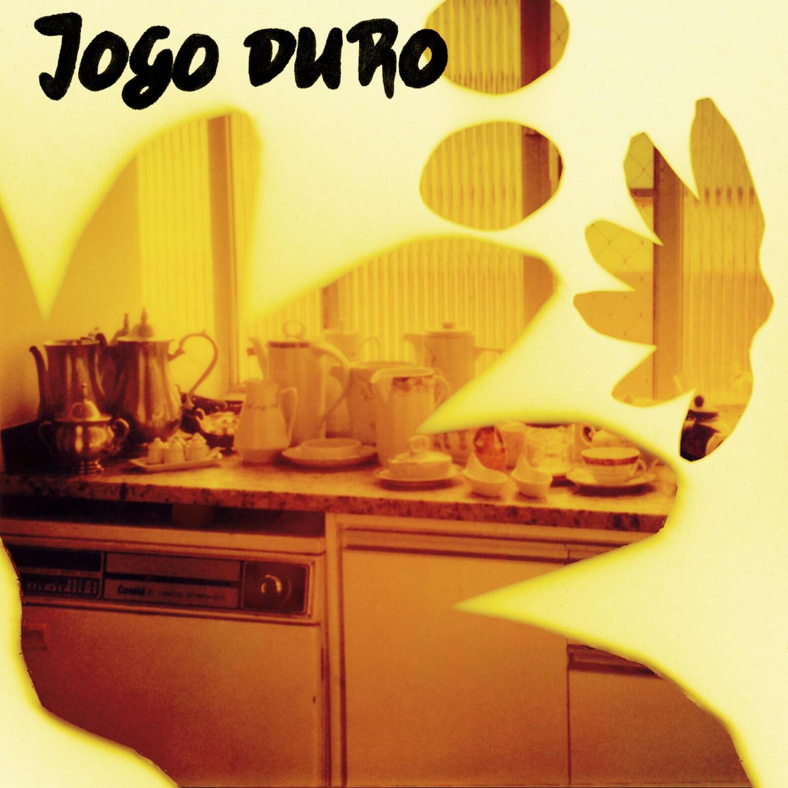 Vinyl record cover: kitchen scene with a hand and warm yellow tones.