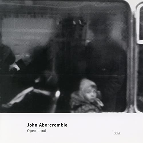 Black and white CD cover with figures and text “John Abercrombie Open Land”.