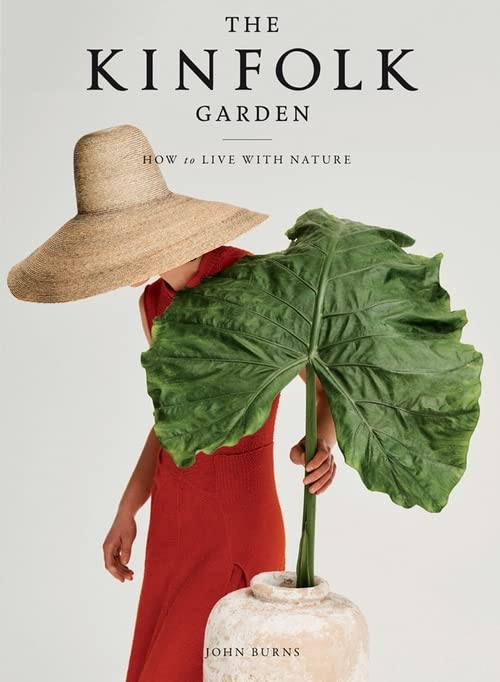 Book cover with person holding a large green leaf and straw hat.