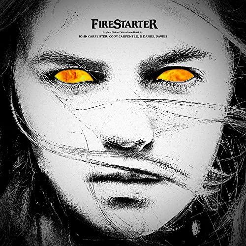 Black and white portrait of a girl with glowing orange eyes.