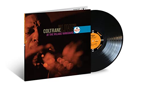 John Coltrane album cover and vinyl record on white background.