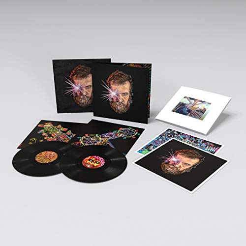 Vinyl record set including two black discs, album covers, and art prints on grey.