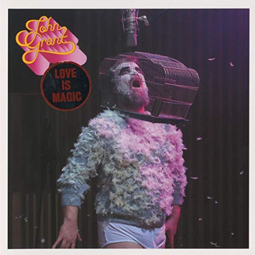 Album cover for John Grant’s “Love Is Magic” featuring a man in a birdcage.