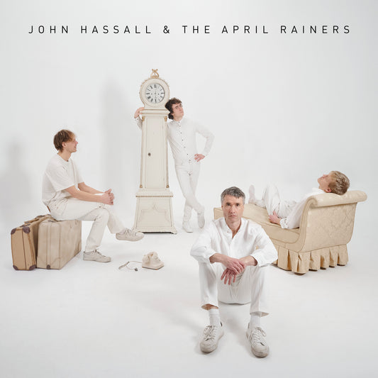 Album cover featuring four people in white clothing with a grandfather clock.