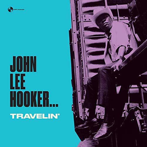 John Lee Hooker wearing a cowboy hat, sitting on a train, on blue background.