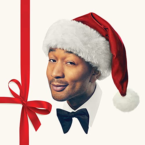 John Legend wearing a Santa hat and black bow tie.
