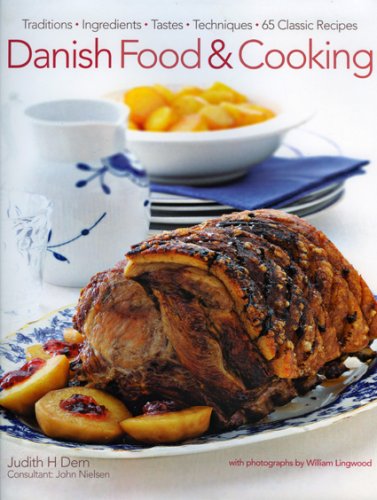 Cookbook cover featuring roasted pork with fruit and blue patterned dishes.