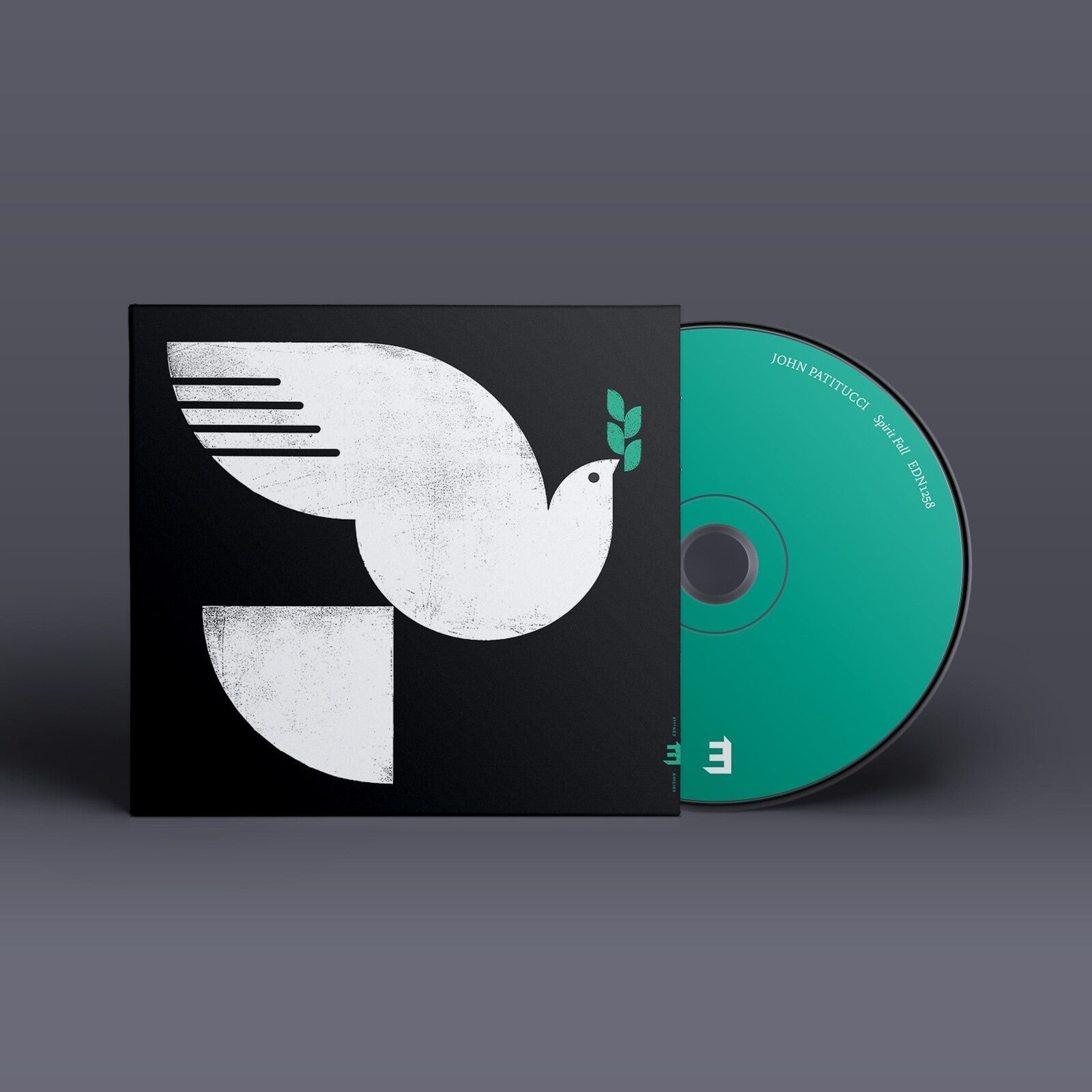 CD case with a white dove on a black cover, disc visible.
