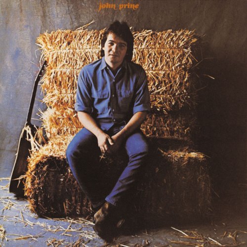 John Prine sitting on hay bales, wearing a blue shirt and jeans.