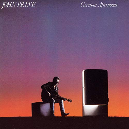 John Prine album cover: man with guitar, refrigerator, sunset sky.