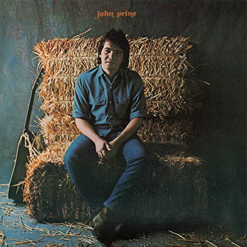 John Prine album cover: man sitting on hay bales, denim shirt.