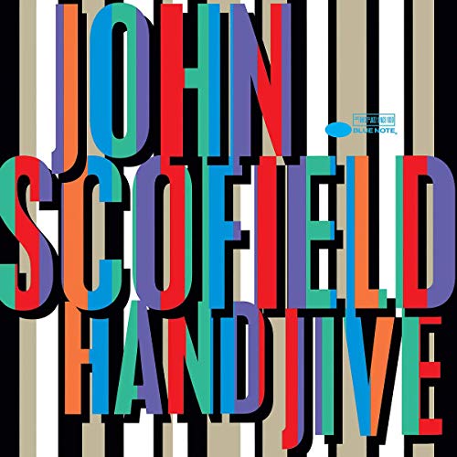 "Album cover with multicolored text 'John Scofield Hand Jive' on black, white, and tan stripes."