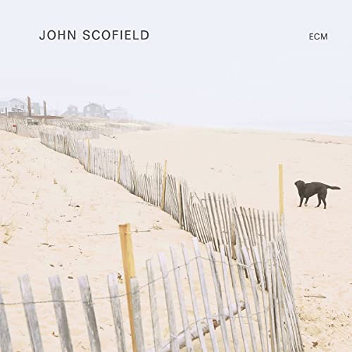 Album cover for John Scofield featuring a beach, fence, and dog.