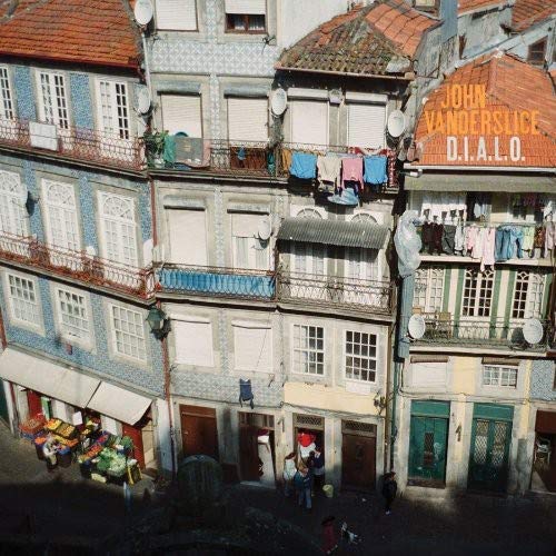Vinyl record cover for John Vanderslice’s “D.I.a.L.O” with a European street scene.