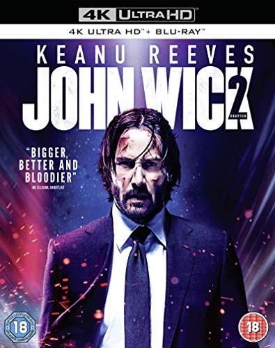 Keanu Reeves as John Wick on a movie cover with purple lighting and sparks.