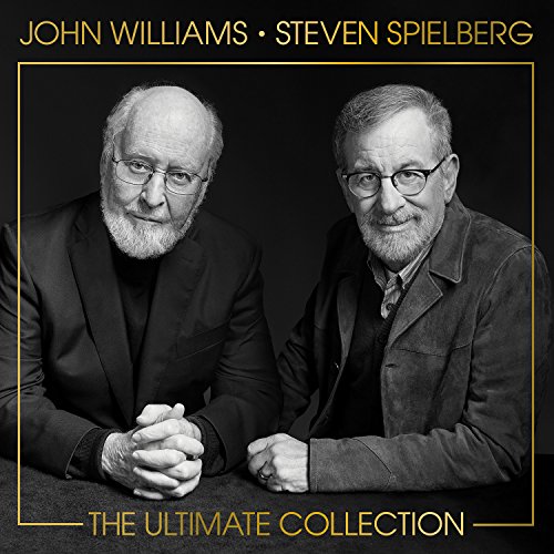 Black and white portrait of John Williams and Steven Spielberg against a dark background.