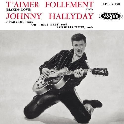 Black and white portrait of Johnny Hallyday playing a guitar.
