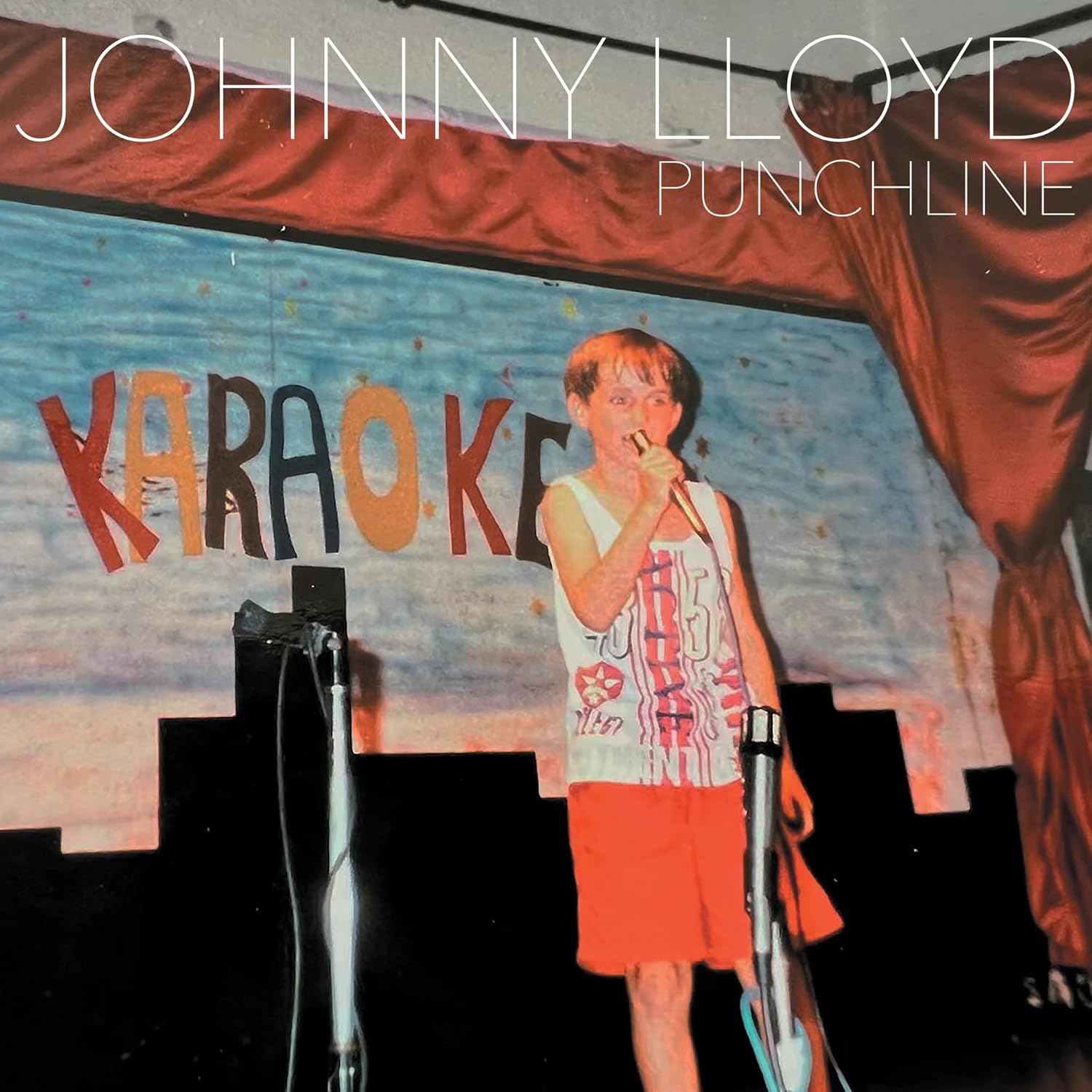 CD cover for Johnny Lloyd’s “Punchline” featuring a man singing karaoke.