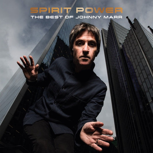 Johnny Marr portrait with city skyscrapers, album cover for “Spirit Power.”