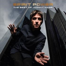 Johnny Marr album cover featuring him in front of skyscrapers with an included disc.