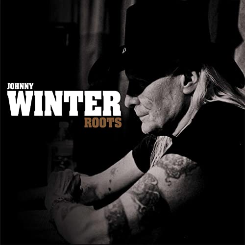 Johnny Winter album cover, black and white portrait of musician with tattoos.