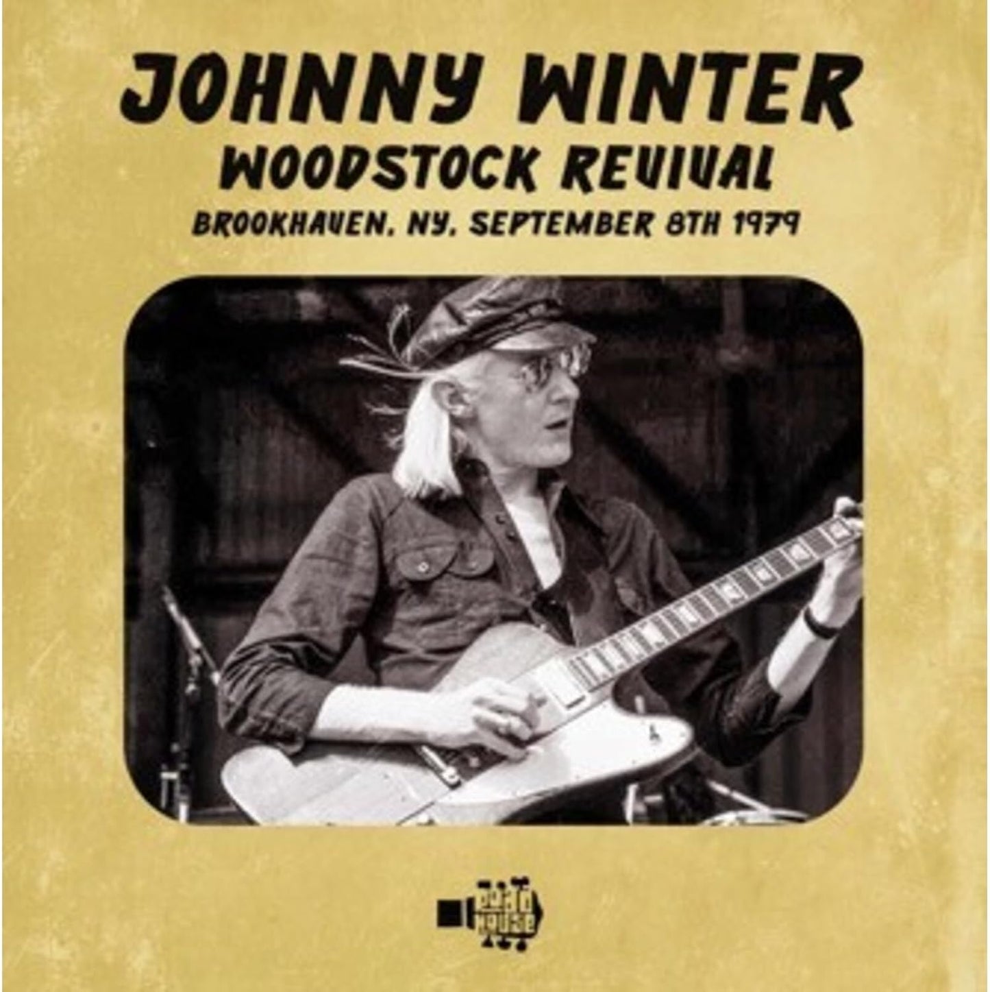 Johnny Winter playing guitar on the "Woodstock Revival" CD cover.