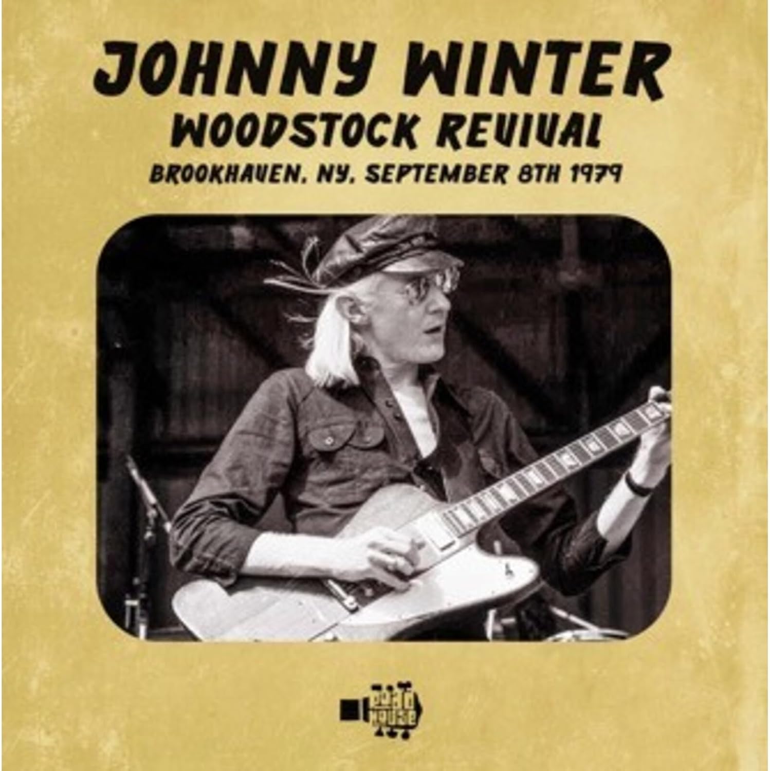 Johnny Winter playing guitar on the "Woodstock Revival" CD cover.