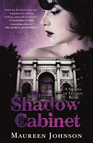 Book cover: woman’s face, shadowy building, purple tones, title “The Shadow Cabinet.”