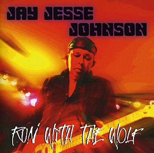 CD cover for Johnsonjay Jesse’s “Run With The Wolf” featuring a guitarist.