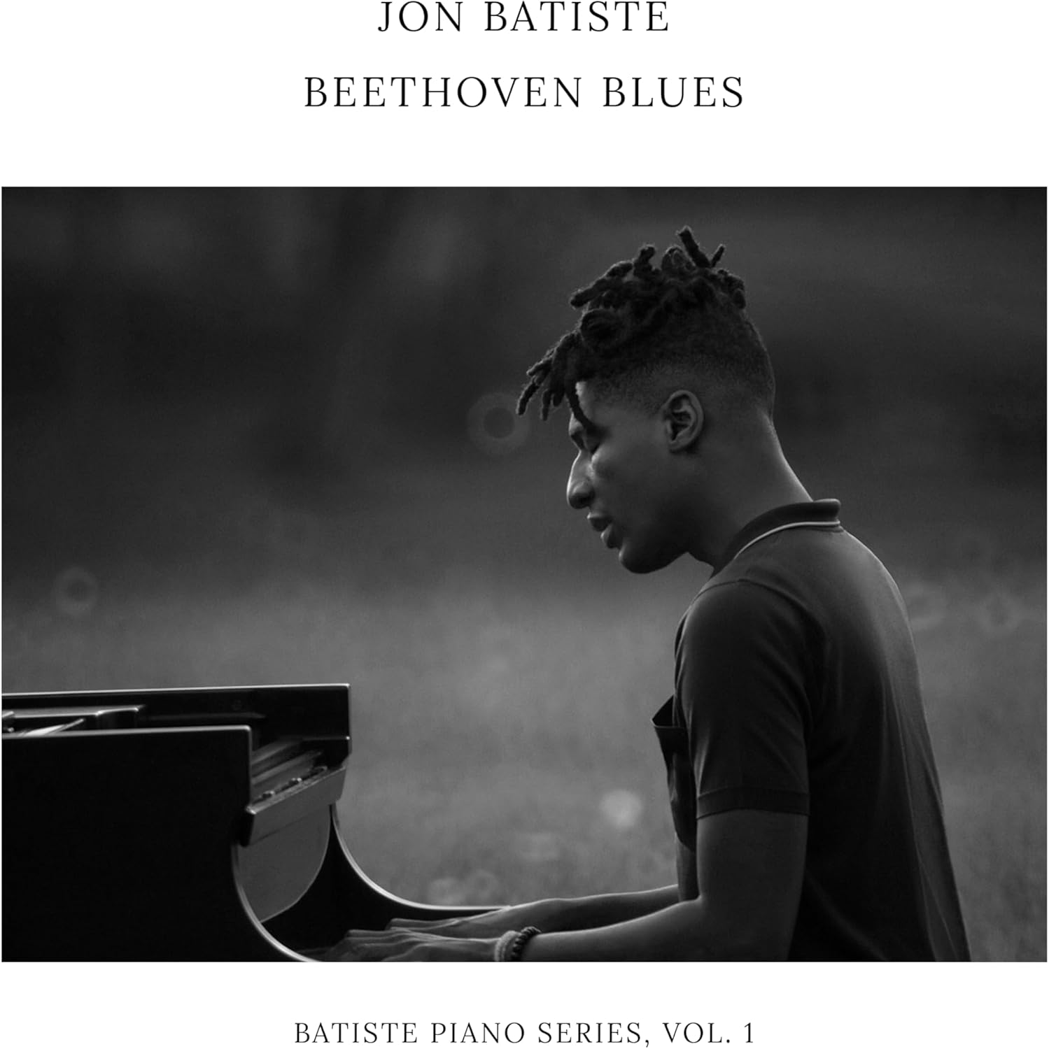 Black and white album cover featuring Jon Batiste playing piano.